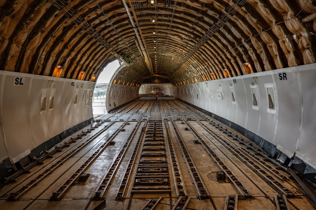 Services Empty cargo plane interior showcasing spacious hold, ready for freight loading.